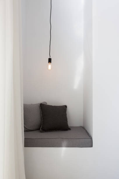 Styled reading nook with grey cushions and pendant light