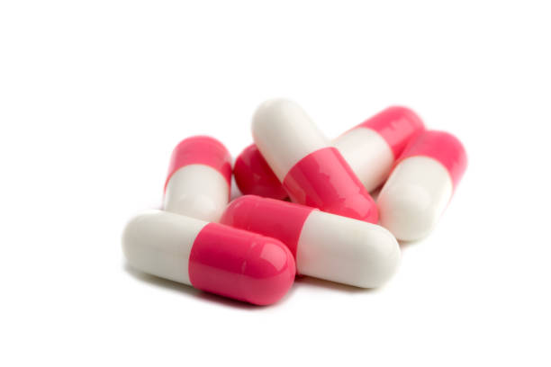 píldoras cápsula antibiótico - pink pill fotografías e imágenes de stock