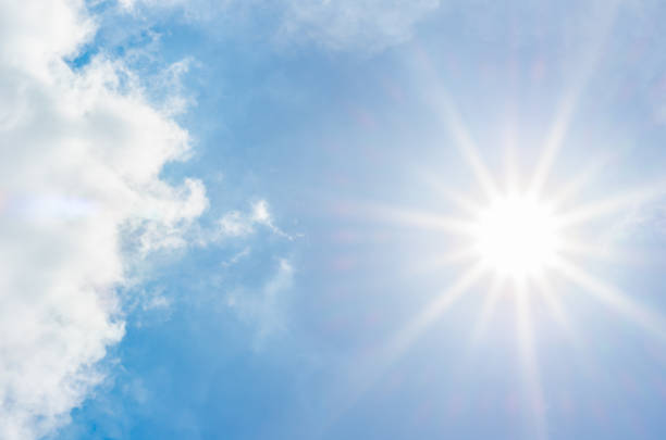 istock looking up at white cloud and sun ray with blue sky 675501846
