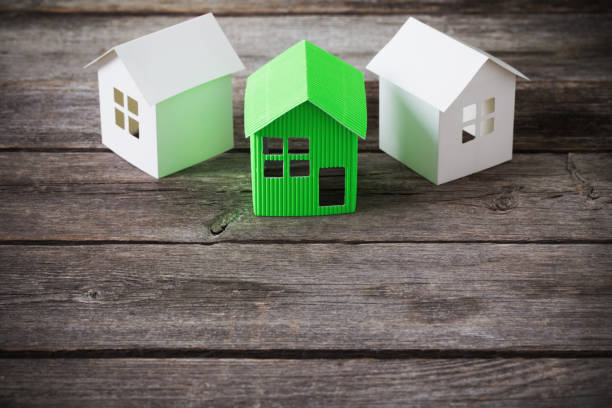 istock paper house on wooden background 675509328