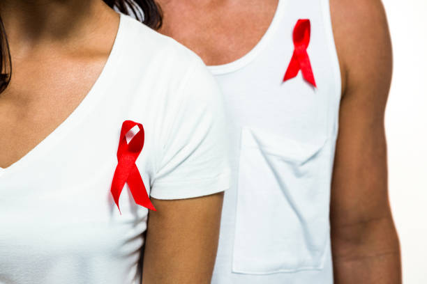 istock Midsection of people with red ribbon on clothes 675511742