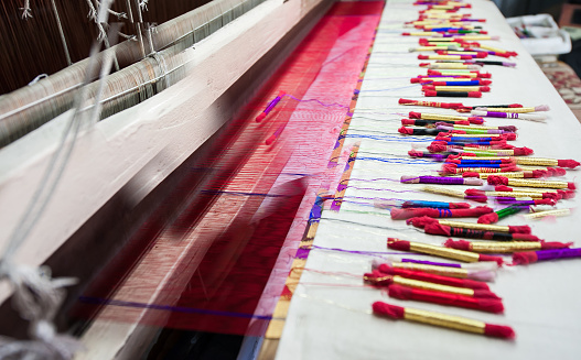 Image of colorful silk Yarn made by Indian weaving loom, Himroo and Paithani technique.