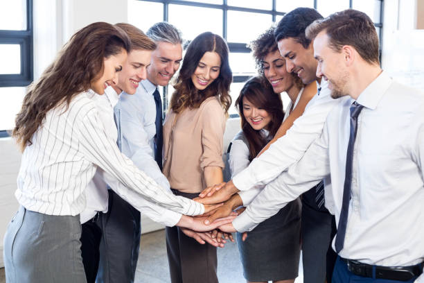 istock Businesspeople stacking hands in office 675515398