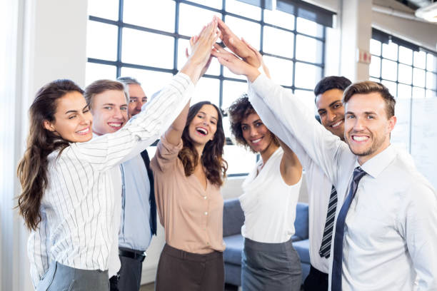 istock Businesspeople stacking hands in office 675515460