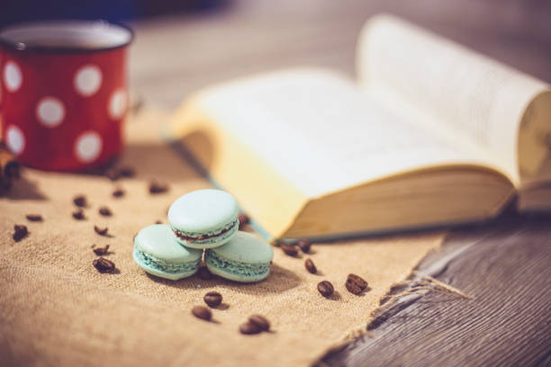 Macaroons cookies and book on wooden rustic table