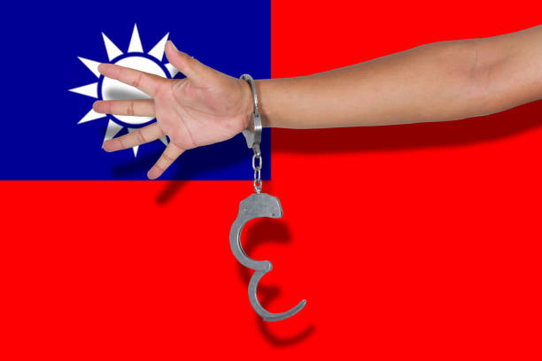 istock handcuffs with hand on Taiwan flag 675523476