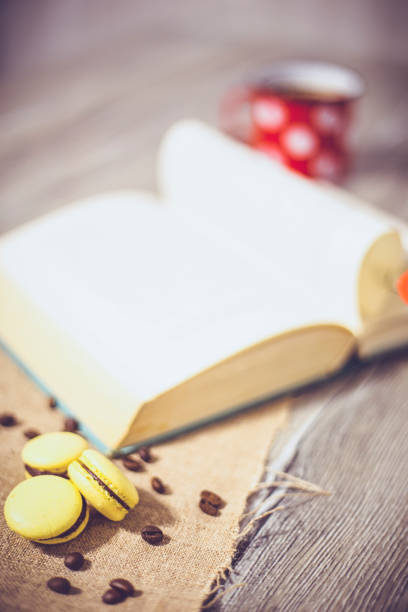 Macaroons cookies and book on wooden rustic table