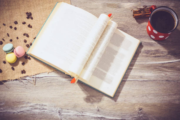 istock Macaroons cookies and book on wooden rustic table 675525922