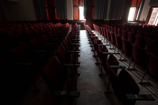 istock Red seats in some empty, dark, old, abandoned cinema theater 675525970