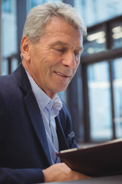 istock Attentive businessman looking at organizer 675526590