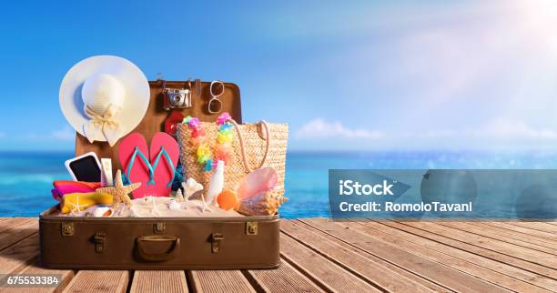 Beach Accessories In Suitcase On Beach Travel Concept Stock Photo - Download Image Now