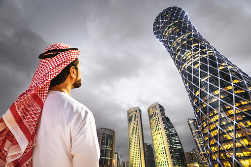 man looking the doha skyline in qatar