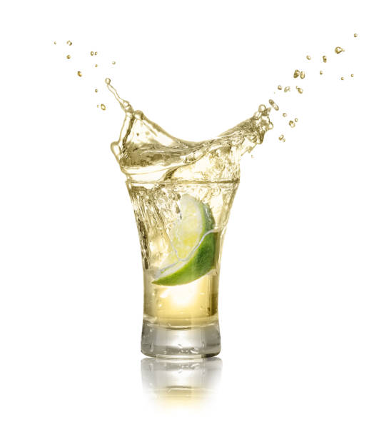 shot of gold tequila with splash stock photo