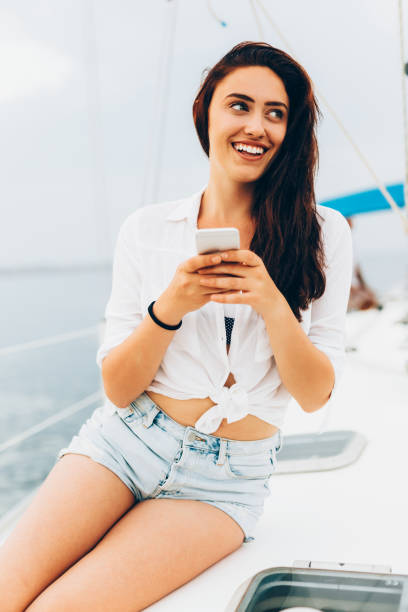 istock Woman texting on a yacht 675540832