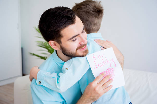 istock Son gives his father a drawing 675543860