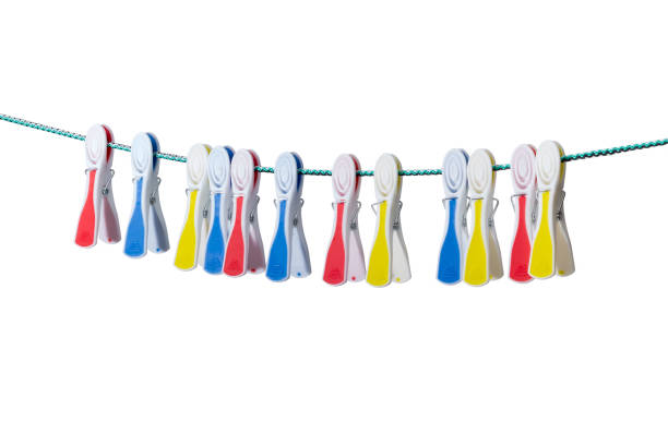 istock Varicolored plastic clothespins hanging on the clothes line 675546664