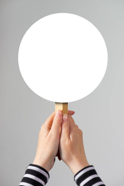 istock Female hand holding blank mock up banner sign 675550336