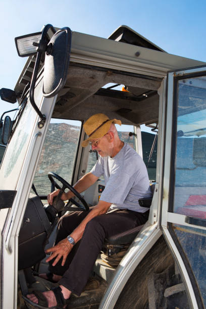 istock Farmer driving tractor with dirty windshield 675563384