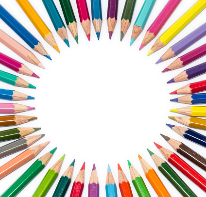 Circle of color pencil on white background with copyspace in the middle