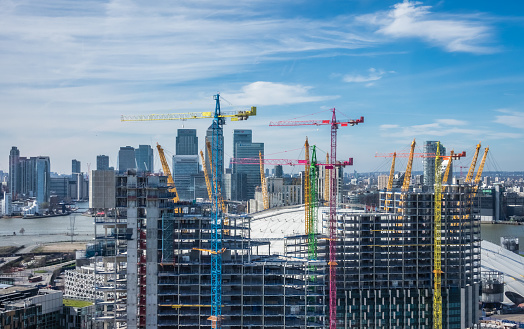 Colorful cranes at work at London building site near the O2 Arena in Greenwich, England, UK