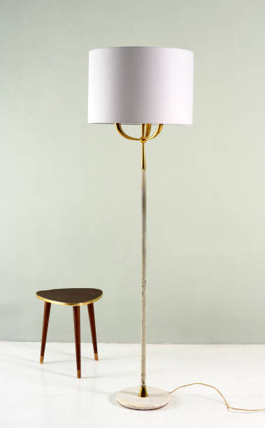 istock Electric floor lamp and tripod stool 675582578