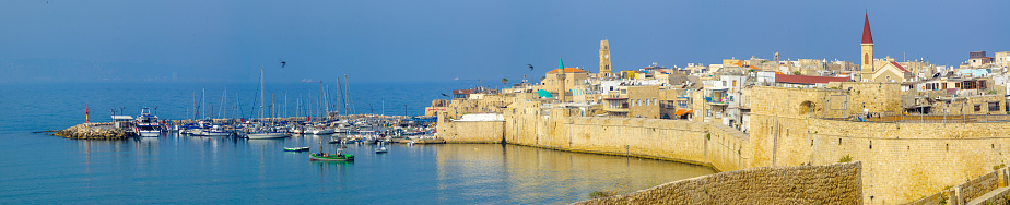 Acre: Panoramic view of the city walls, the fishing harbor, and the old city skyline, in Acre (Akko), Israel
