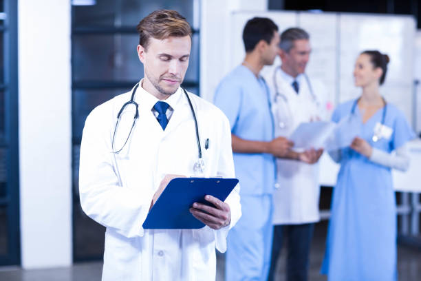 istock Doctor writing a medical report 675586098