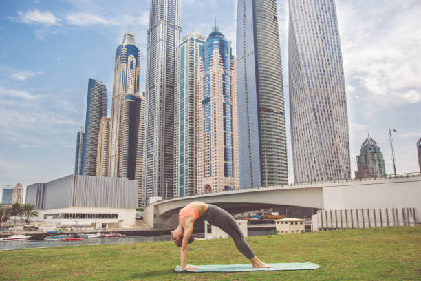 Young girl doing stretching against skyscrapers stock photo
