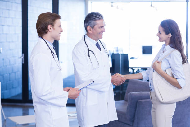 istock Doctor shaking hands with colleague 675586898