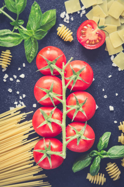 istock Pasta ingredients. Cherry tomatoes, pasta, fresh basil, spices 675587038