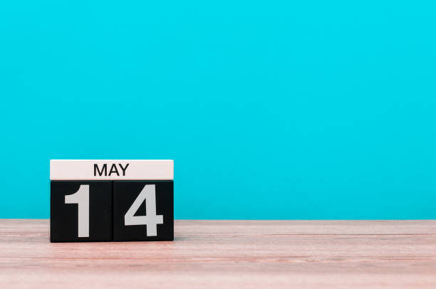 istock May 14th. Day 14 of month, calendar on turquoise background. Spring time, empty space for text. Astronomy Day. World Fair Trade DAY 675593214