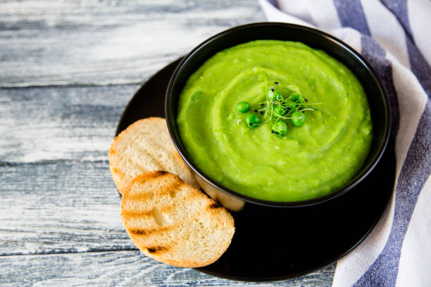 istock Homemade puree soup with green peas and micro greens 675593690