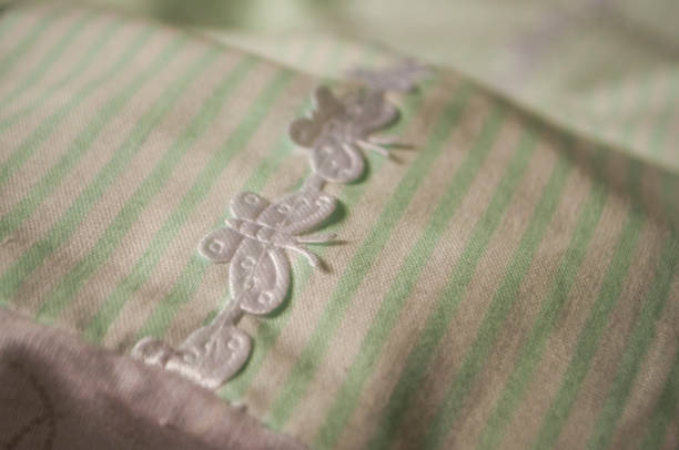 istock Turquoise textile with white stripes and lace with butterflies 675602972