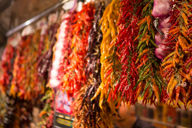 istock Different types of chilli hanging from a stall at a market on Las Ramblas 675605612