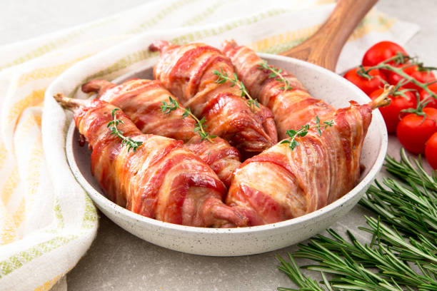 istock baked quail wrapped in bacon on a slate board 675608924