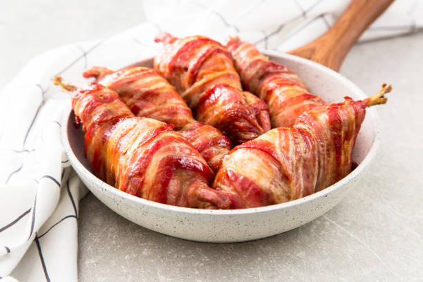 istock baked quail wrapped in bacon on a slate board 675609184