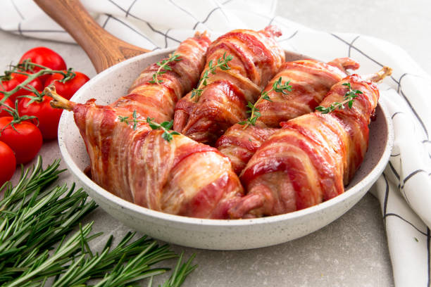 istock baked quail wrapped in bacon on a slate board 675609304