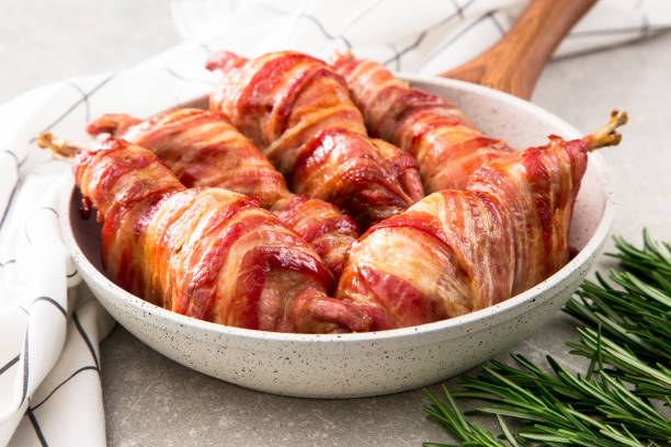 istock baked quail wrapped in bacon on a slate board 675609730