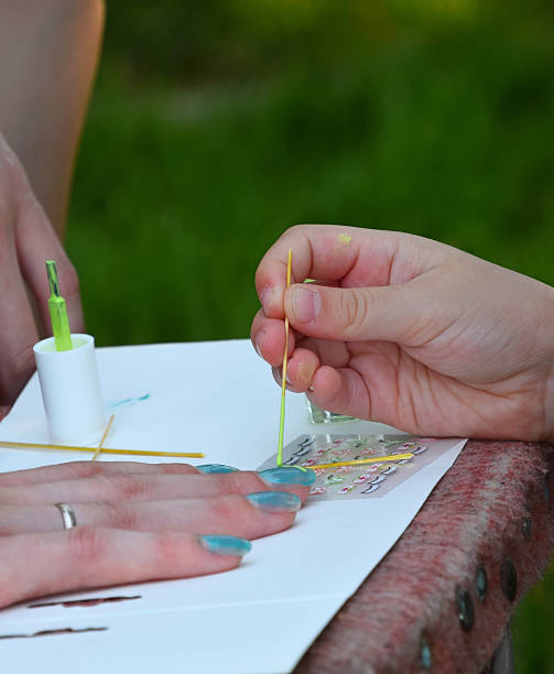 istock Cropped Image Of Girl Practicing Nail Art On Hand 675610283