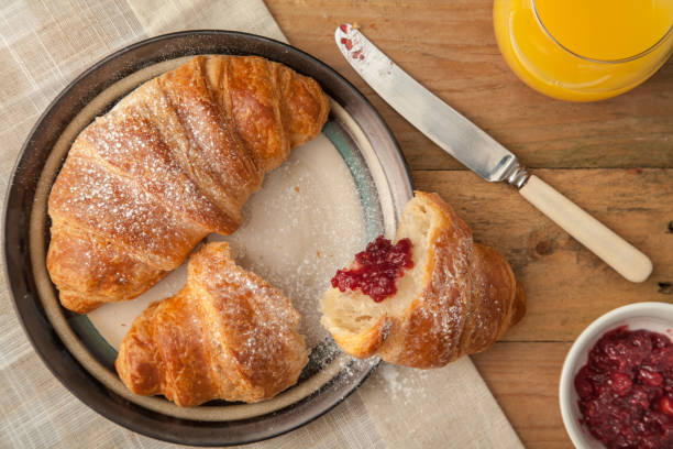 istock Top view of fresh croissants on a breakfast table setting 675612784