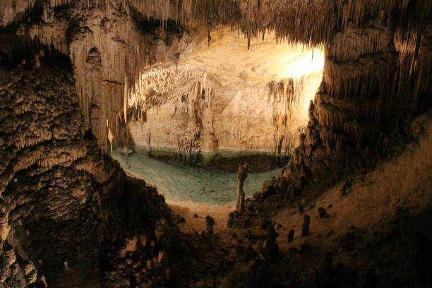 istock inside of a big cave with a puddle of water 675620554