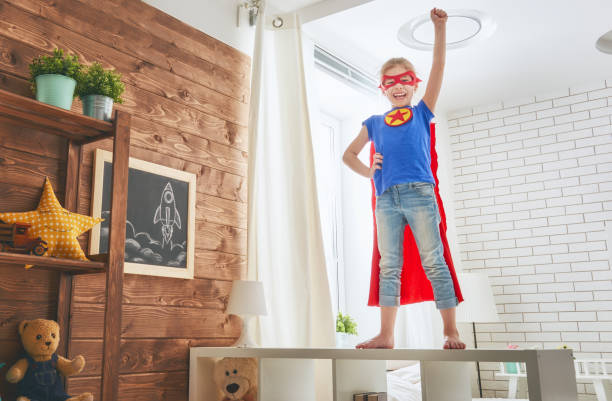 istock child plays superhero 675630356