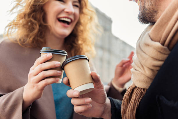 istock Cheerful man and woman drinking hot beverage 675630996