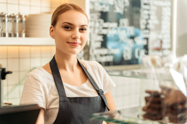 istock Joyful saleswoman working in confectionery 675637940