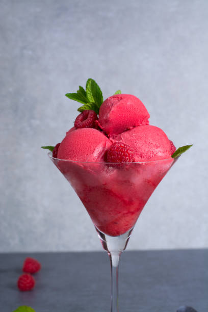istock Raspberry ice cream sorbet in glass with raspberry, mint leaves  copy space on grey textured background 675638042