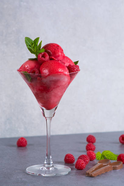 istock Raspberry ice cream sorbet in glass with chocolate spoon, raspberry, mint leaves  copy space 675638050