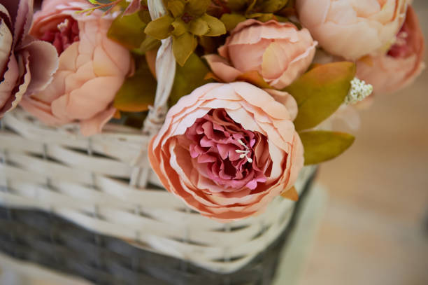 istock peony artificial rose in a box, standing on the windowsill . Pink peonies 675638194