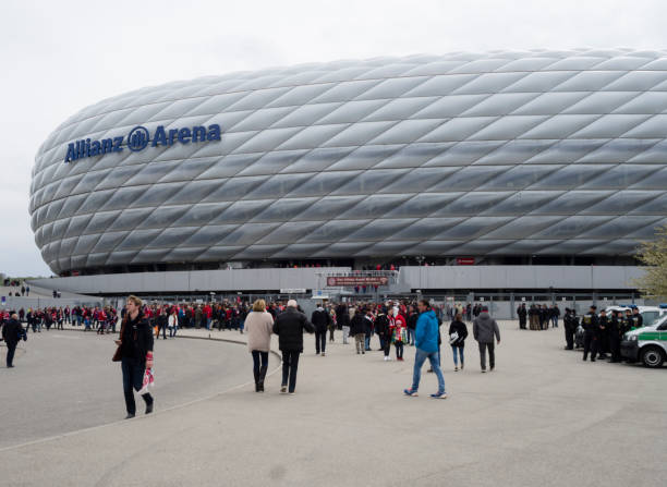 Allianz Arena, Munich Munich, Germany - 22 April 2017: Football fans are entering the Allianz Arena football stadium in Munich, Germany. With 75'000 seats, Allianz Arena is one of Germany's largest sports stadiums and home of FC Bayern Munich. allianz arena stock pictures, royalty-free photos & images