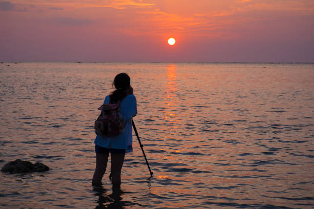 Silhouette of photographer is taking the sunset