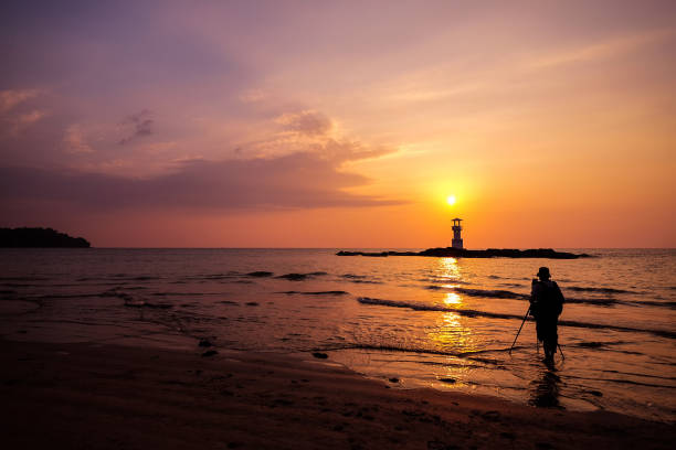 Silhouette of photographer is taking the sunset